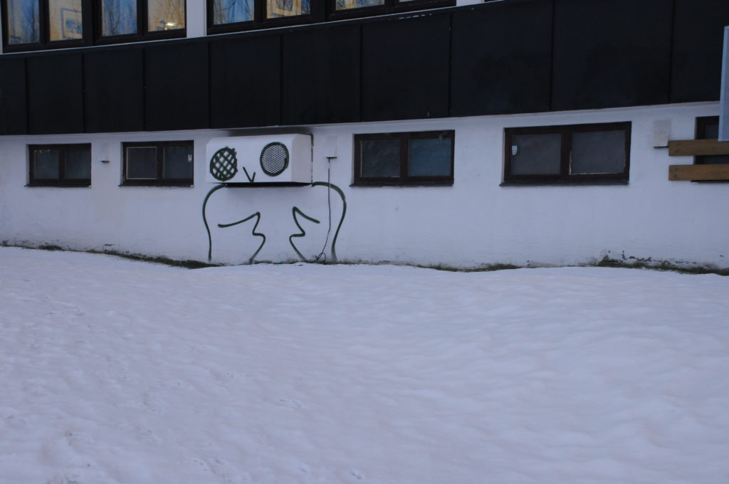 A large owl is painted on the side of a building in Tromsø, Norway.