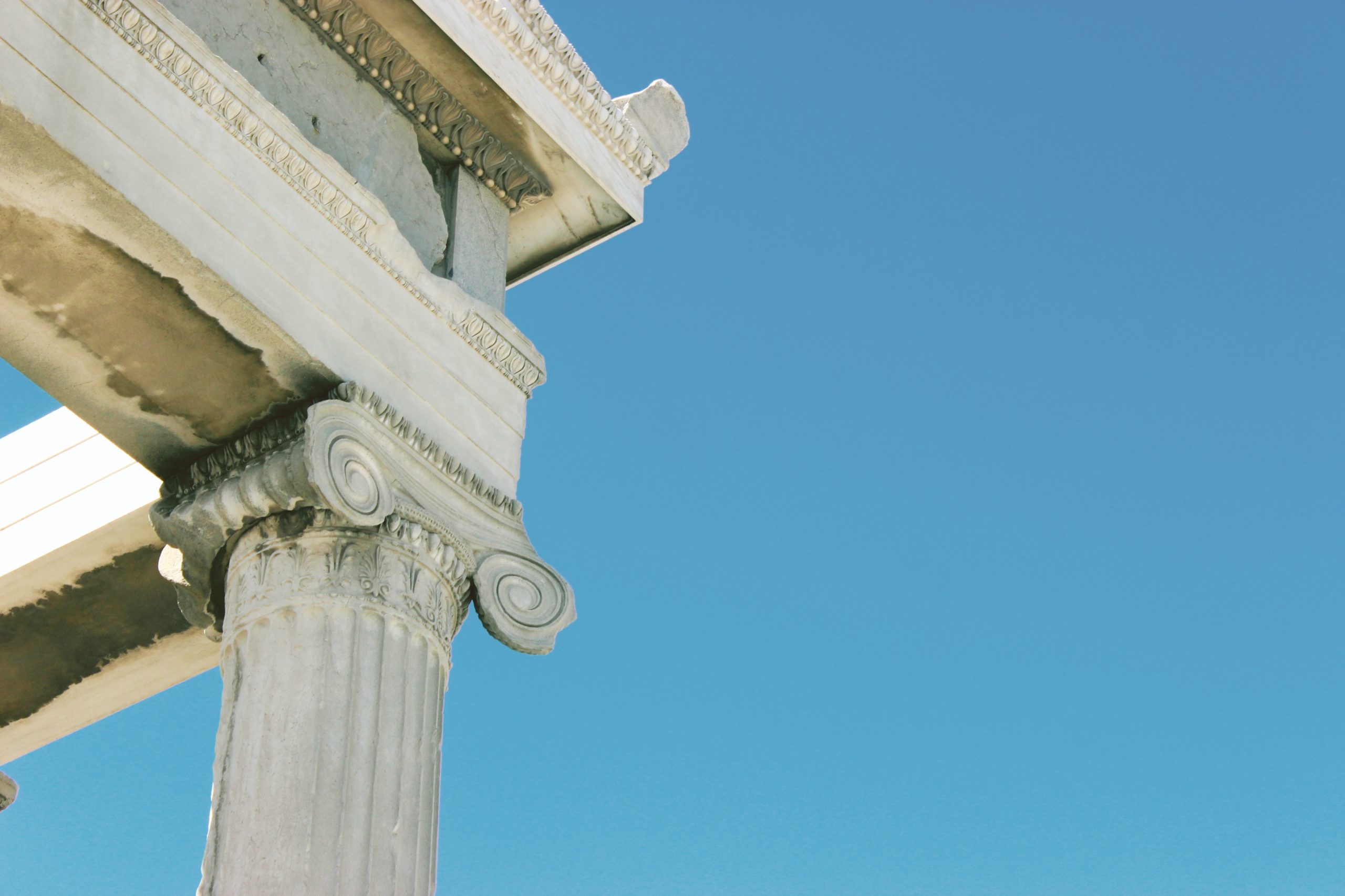 A color photo of a pillar supporting a corner of the roof of the Acropolis.